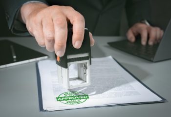 hands-businessman-stamp-paper-document-approve-business-investment-contract-agreement-closeup-person-hand-stamping-with-approved-stamp-document-desk