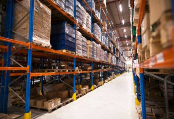 interior-large-distribution-warehouse-with-shelves-stacked-with-palettes-goods-ready-market